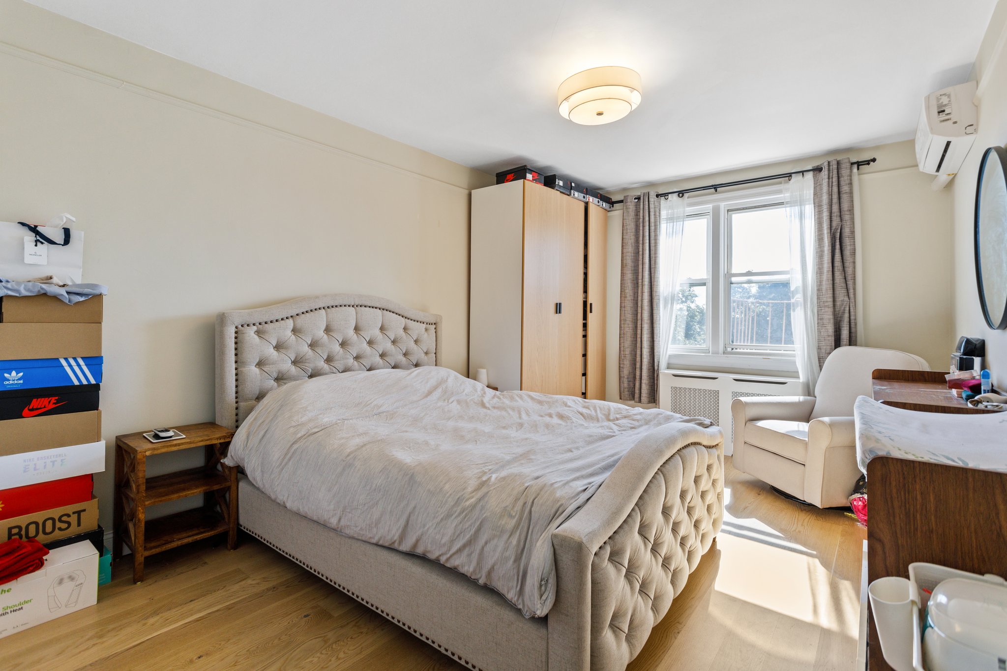 22-45 47th Street, Unit 3 Queens, NY 11105 - Photo 9 of 14 a bedroom with a bed and a large window