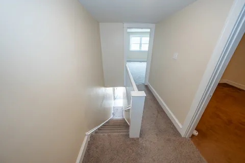 a view of a hallway with staircase