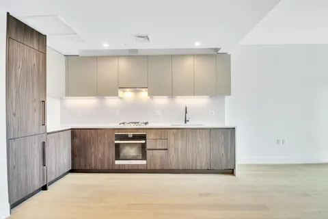 a kitchen with stainless steel appliances a sink a stove a microwave and cabinets