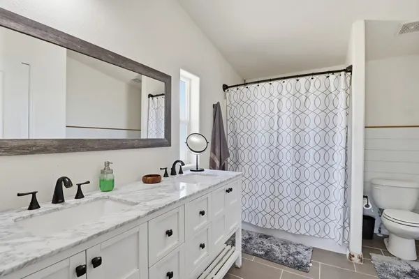a view of walk in closet with clothes