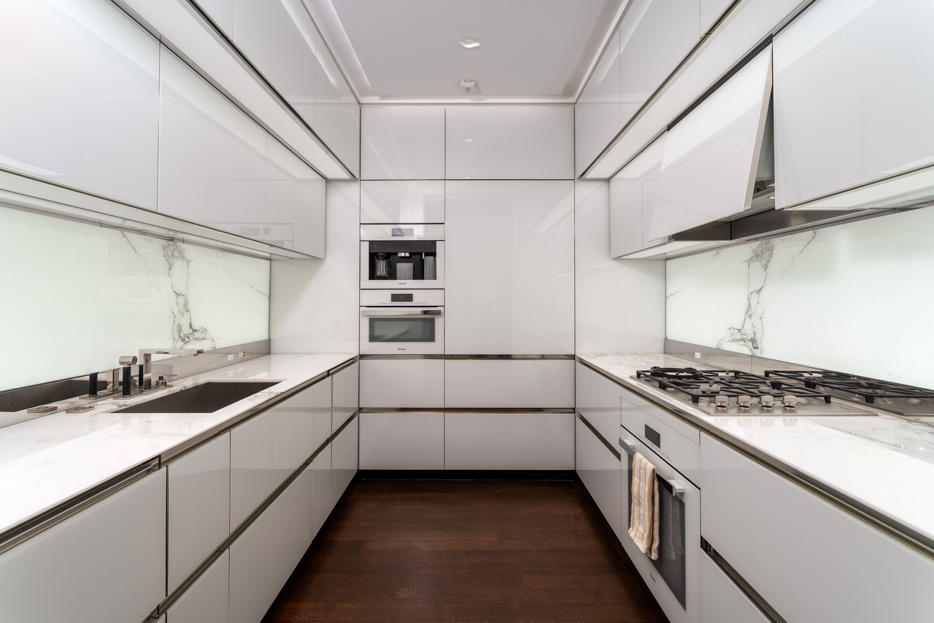 53 West 53rd Street, Unit 20E Manhattan, NY 10019 - Photo 5 of 11 a kitchen with stainless steel appliances granite countertop a sink and cabinets
