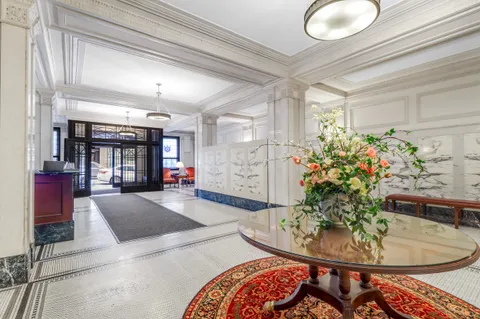 a living room with furniture and flowers