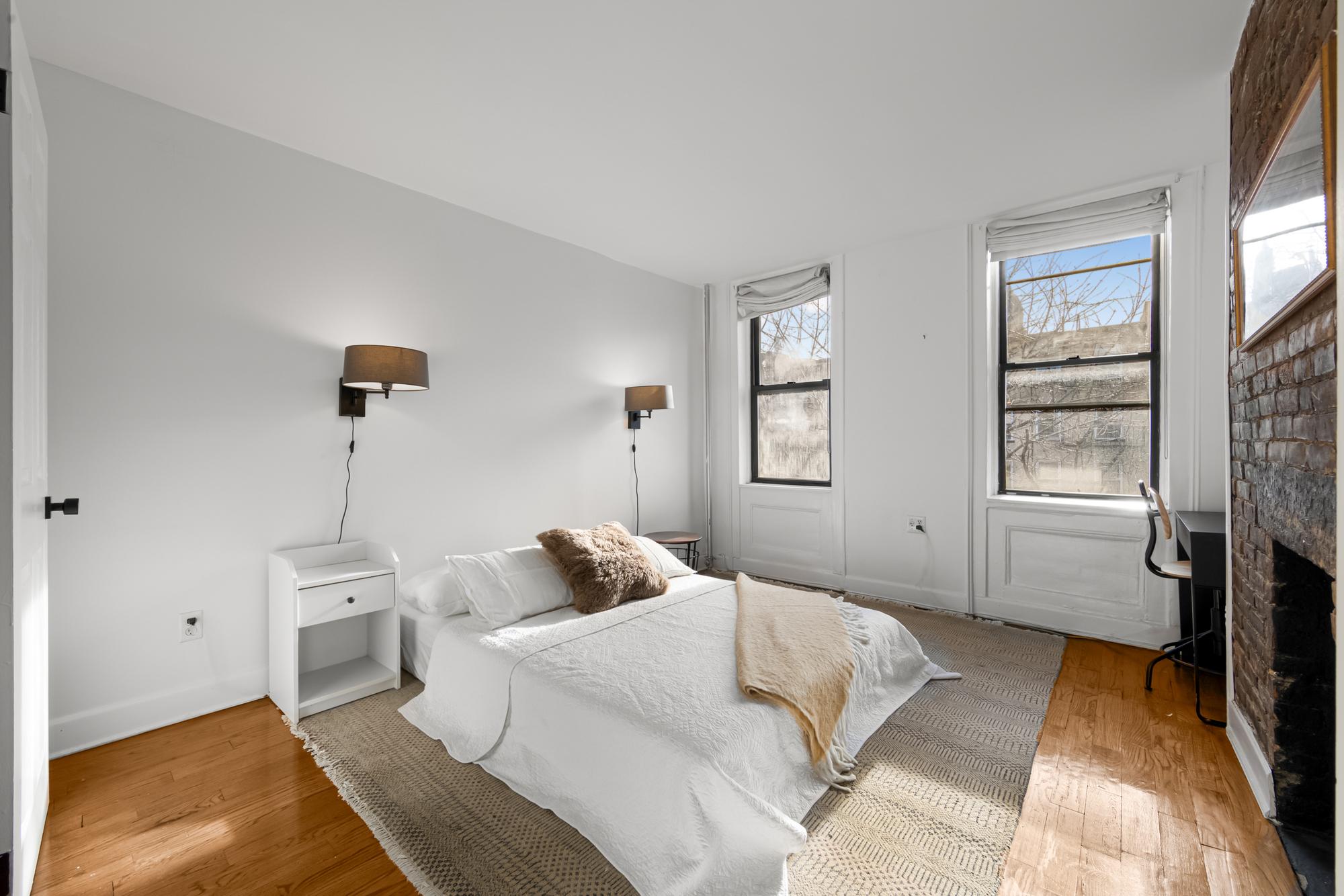 504 East 6th Street, Unit 5 Manhattan, NY 10009 - Photo 6 of 11 a bedroom with a bed and a window