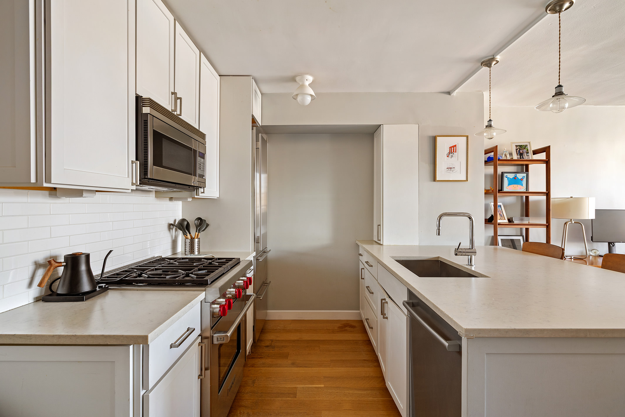 61 Jane Street, Unit 19J Manhattan, NY 10014 - Photo 8 of 16 a kitchen with stainless steel appliances granite countertop a sink and a stove