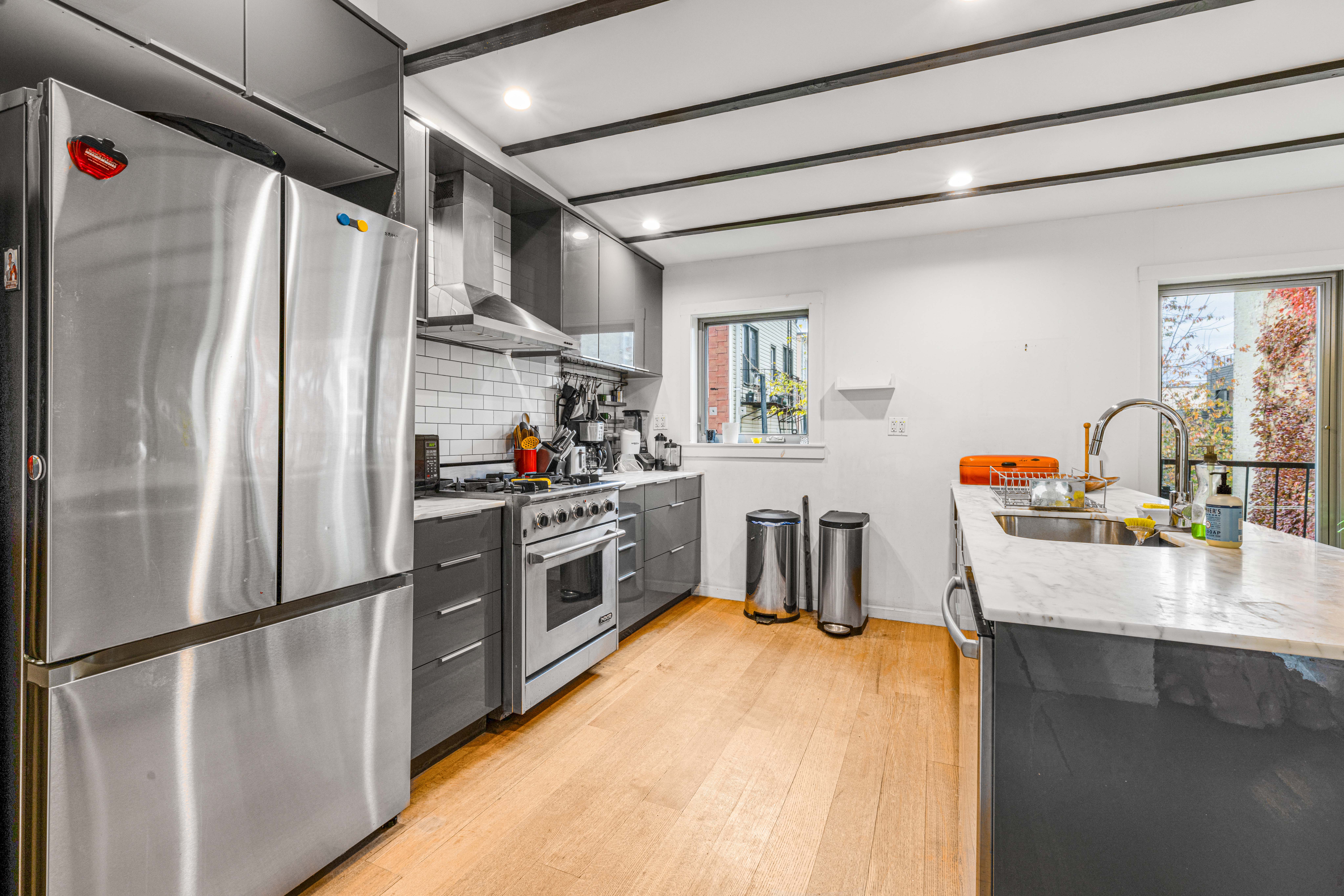 209 Calyer Street, Unit 2 Brooklyn, NY 11222 - Photo 6 of 17 a kitchen with stainless steel appliances a refrigerator and a stove top oven