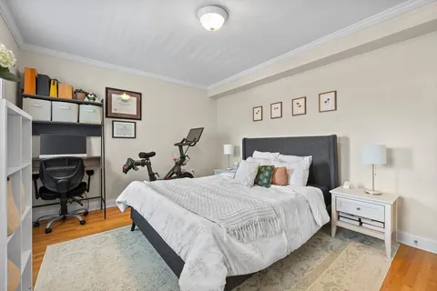 a bedroom with a bed and a desk