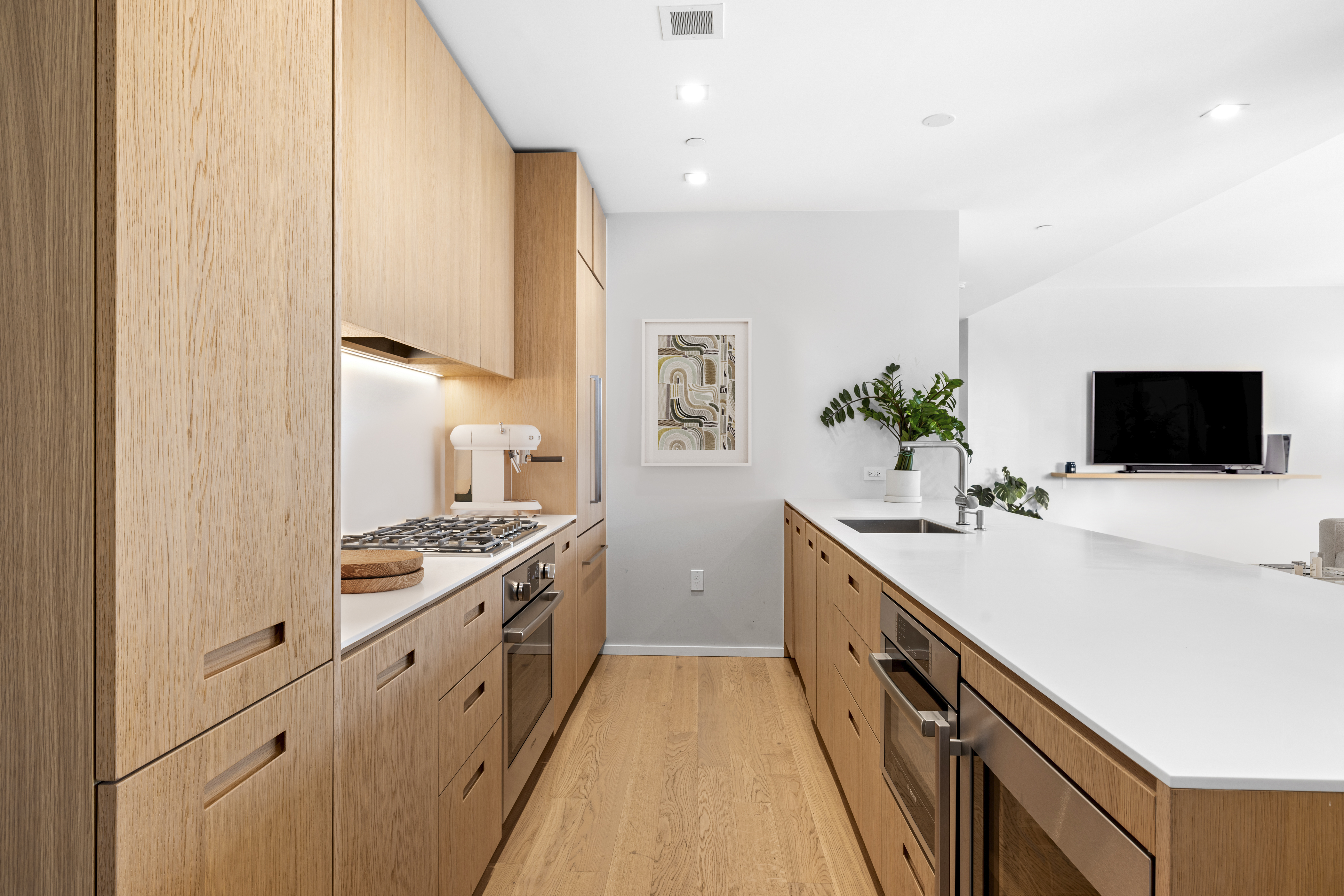 98 Front Street, Unit PH Brooklyn, NY 11201 - Photo 6 of 26 a kitchen with a sink and a stove top oven