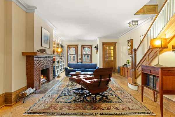 a living room with furniture fireplace and a window