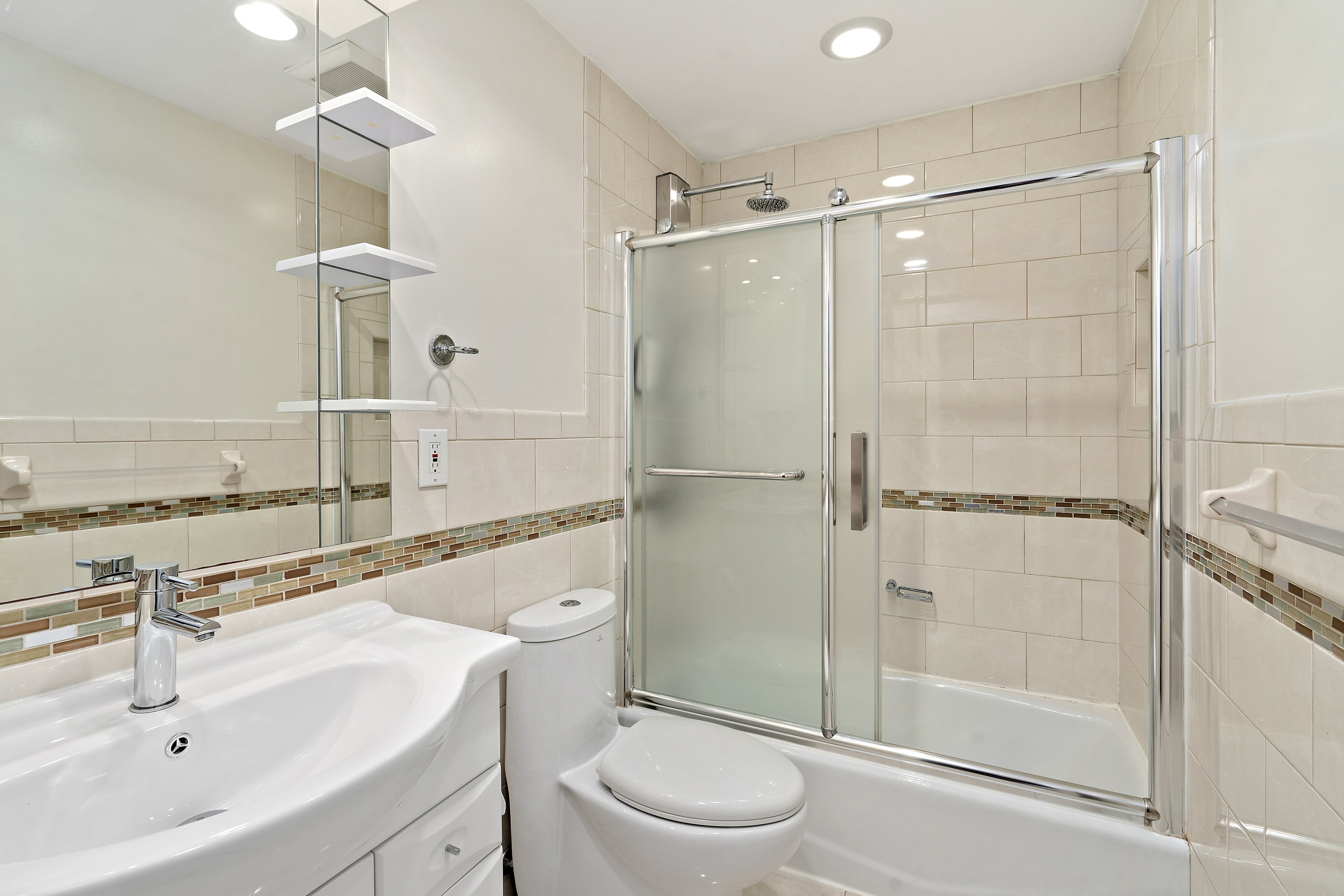 3230 Johnson Avenue, Unit 3 Bronx, NY 10463 - Photo 15 of 21 a bathroom with a shower sink vanity mirror and toilet