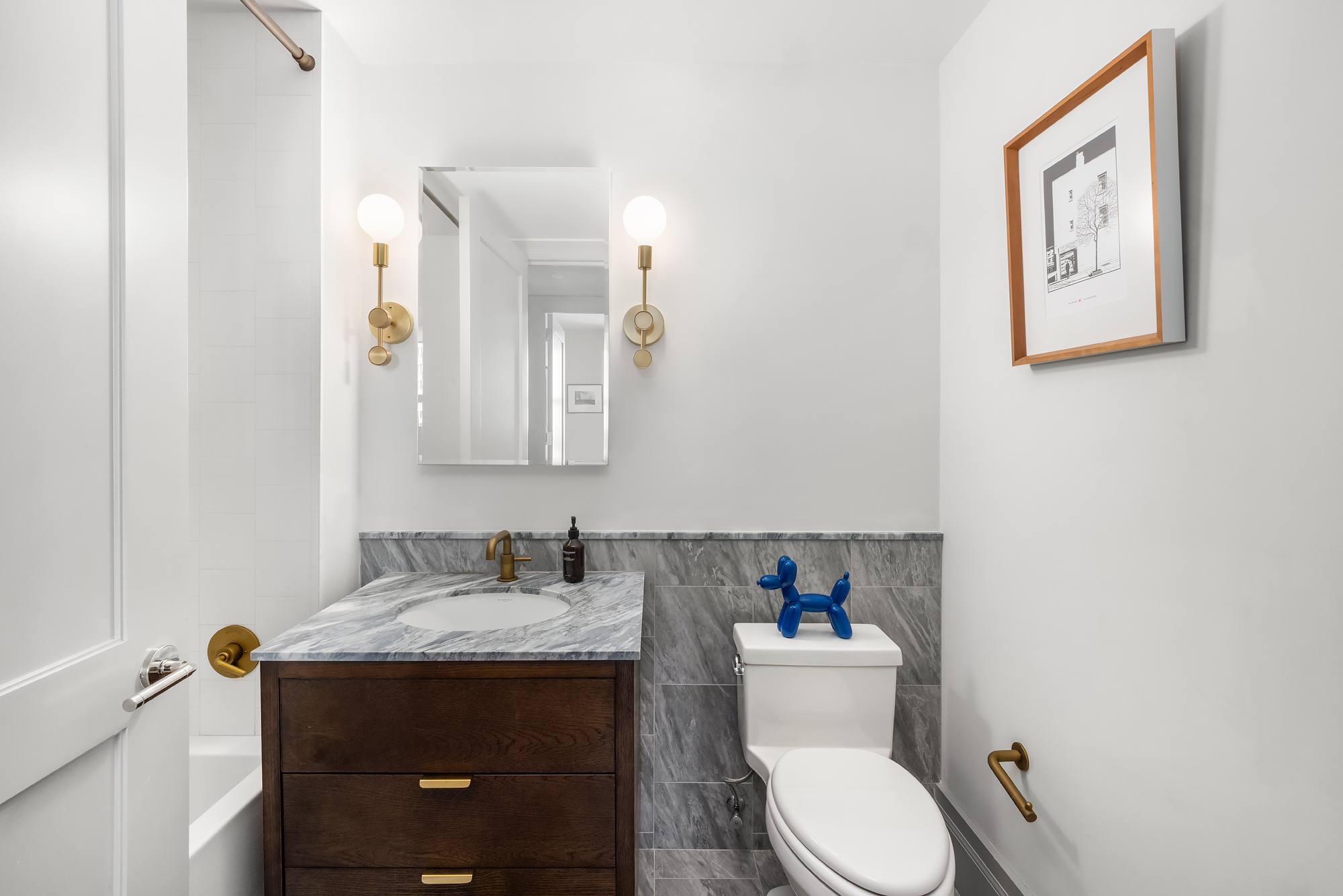 76 Schermerhorn Street, Unit 4C Brooklyn, NY 11201 - Photo 9 of 10 a bathroom with a toilet sink vanity and mirror