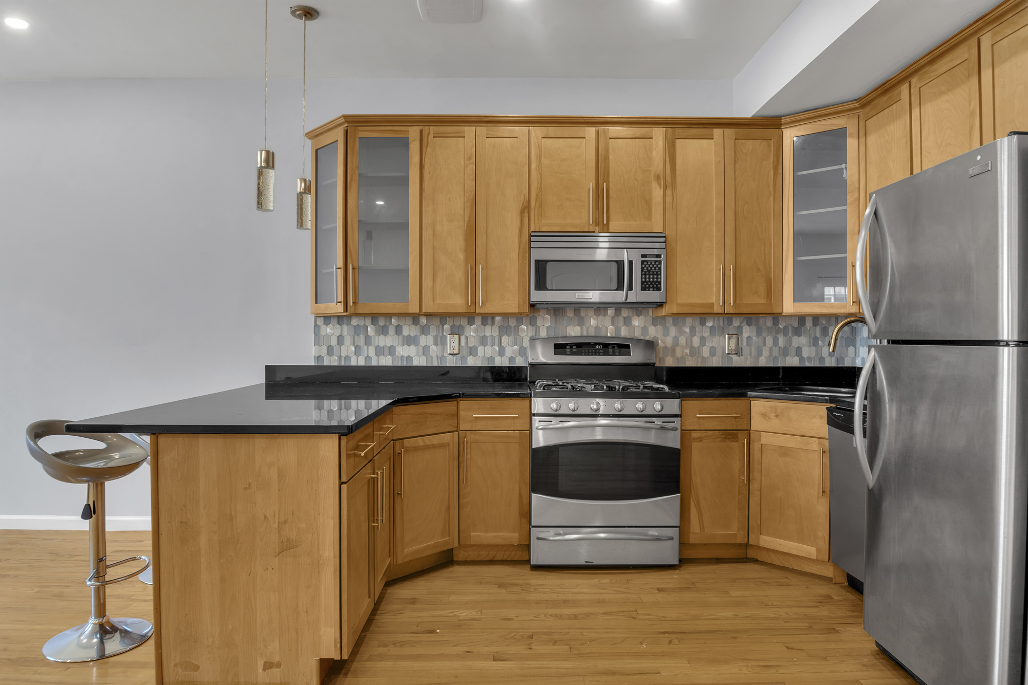 963 Kent Avenue, Unit D3 Brooklyn, NY 11205 - Photo 4 of 16 a kitchen with stainless steel appliances granite countertop a stove a sink and a refrigerator