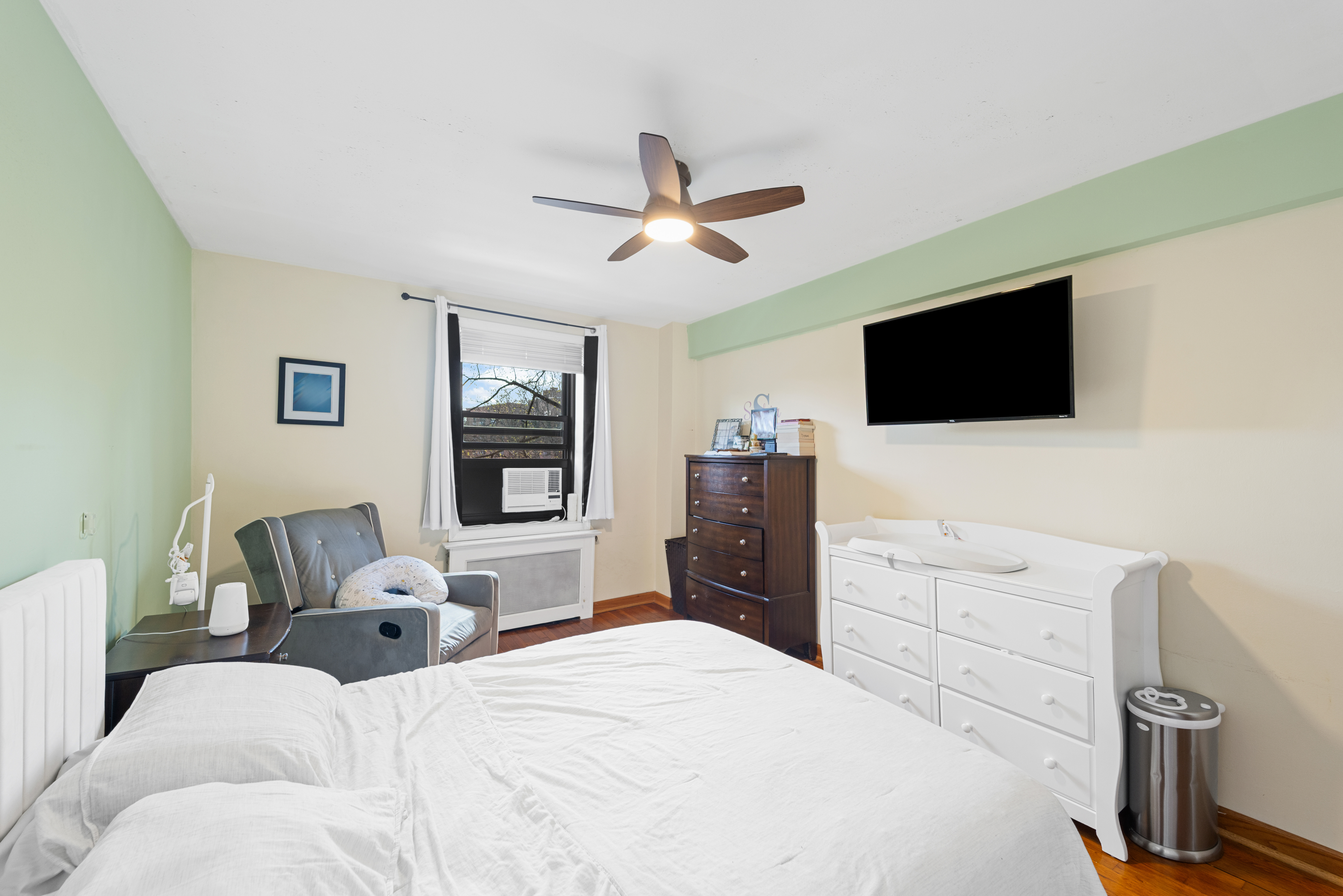 211-01 75th Avenue, Unit 4O Queens, NY 11364 - Photo 4 of 19 a bedroom with a bed and a flat screen tv