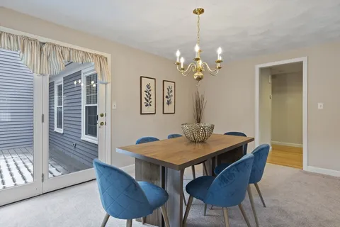 a view of a dining room with furniture wooden floor and chandelier