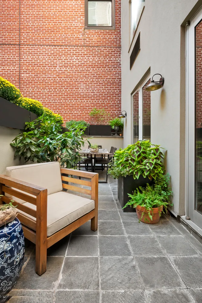 a view of a bench in the backyard