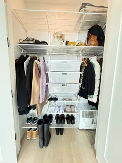 a view of walk in closet with clothes and shoes