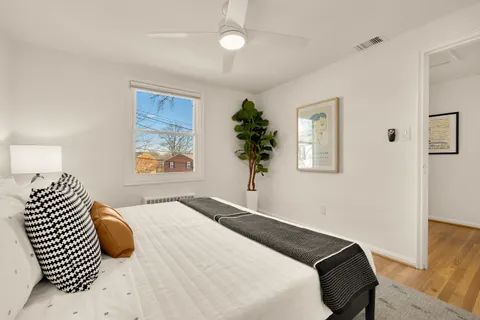 a bedroom with a bed and a window