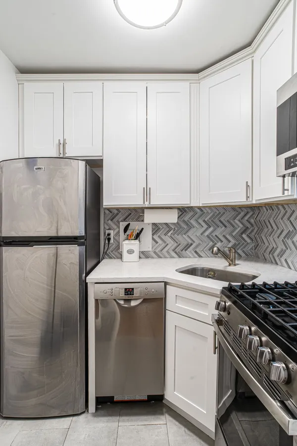 a kitchen with a stove and a refrigerator