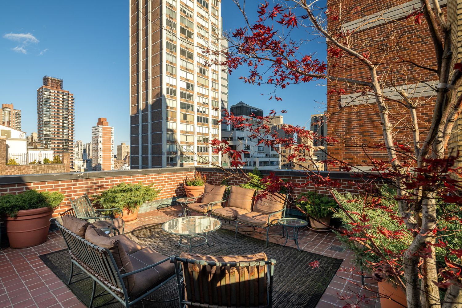 a view of a balcony with chairs and a potted plant