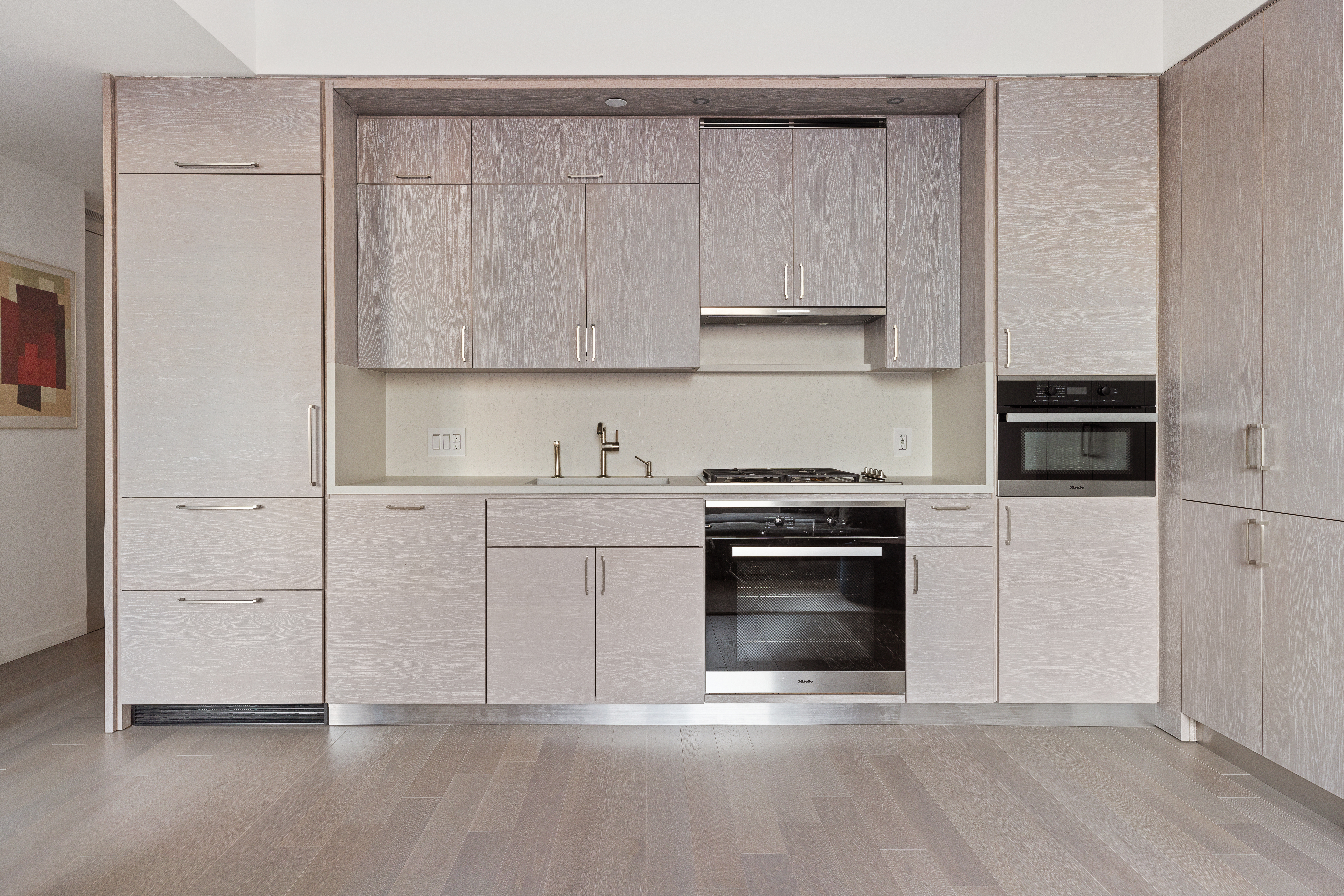 1 City Point, Unit 30D Brooklyn, NY 11201 - Photo 2 of 11 a kitchen with granite countertop white cabinets and stainless steel appliances