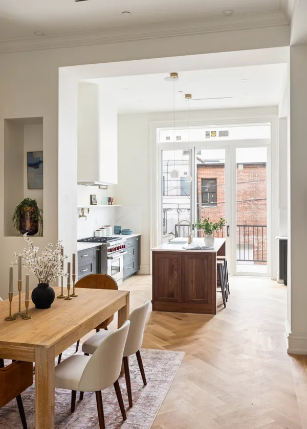 a kitchen with a table chairs and a refrigerator