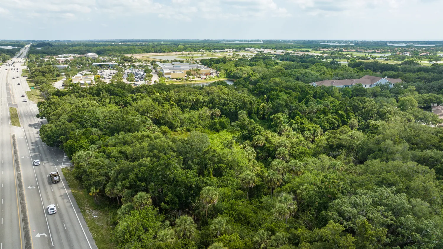 an aerial view of residential houses with city view