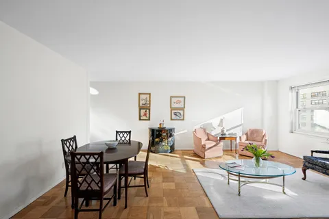 a dining room with a wooden table and chairs