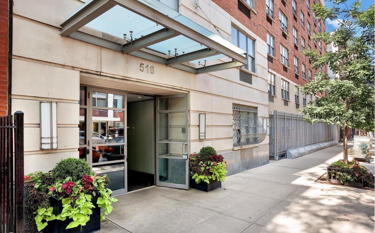 516 West 47th Street, Unit S1B Manhattan, NY 10036 - Photo 15 of 17 a front view of a building with flowers