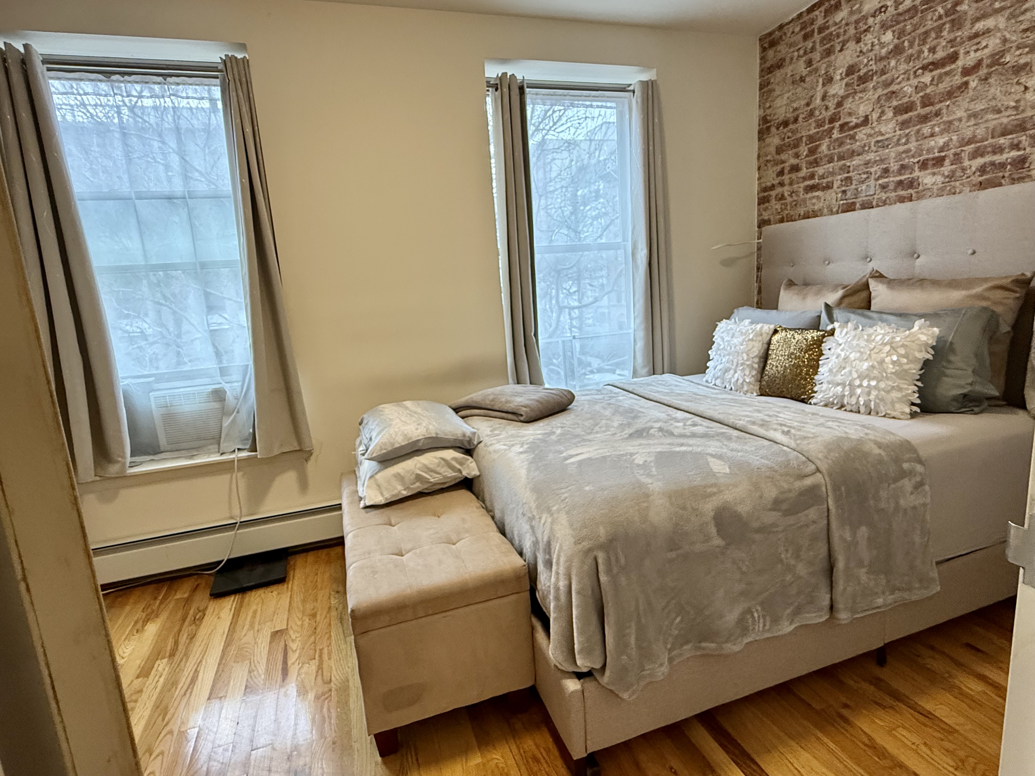 Convent Avenue Manhattan, NY 10031 - Photo 6 of 12 a bedroom with a bed and wooden floor