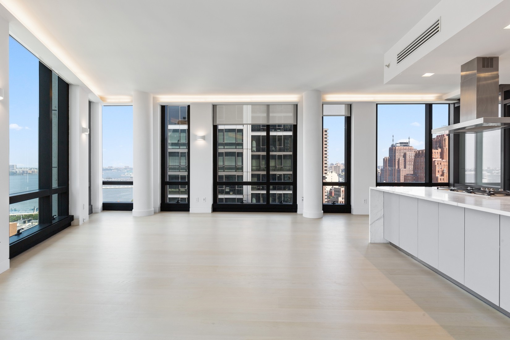 101 Warren Street, Unit 2420 Manhattan, NY 10007 - Photo 2 of 23 an empty room with large mirror and windows