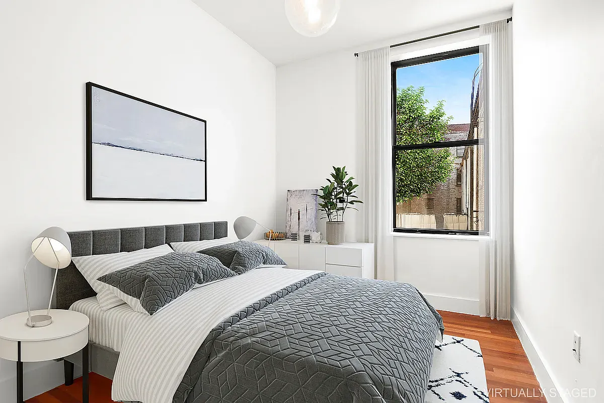 180 Bainbridge Street, Unit 311 Brooklyn, NY 11233 - Photo 3 of 21 a bedroom with a bed and a painting on the wall