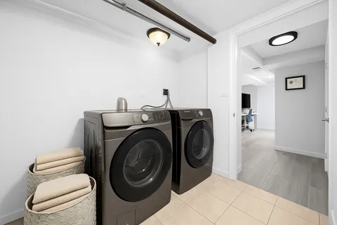 a view of a hallway with washer and dryer