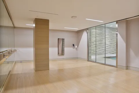 a view of empty room with wooden floor and sliding door