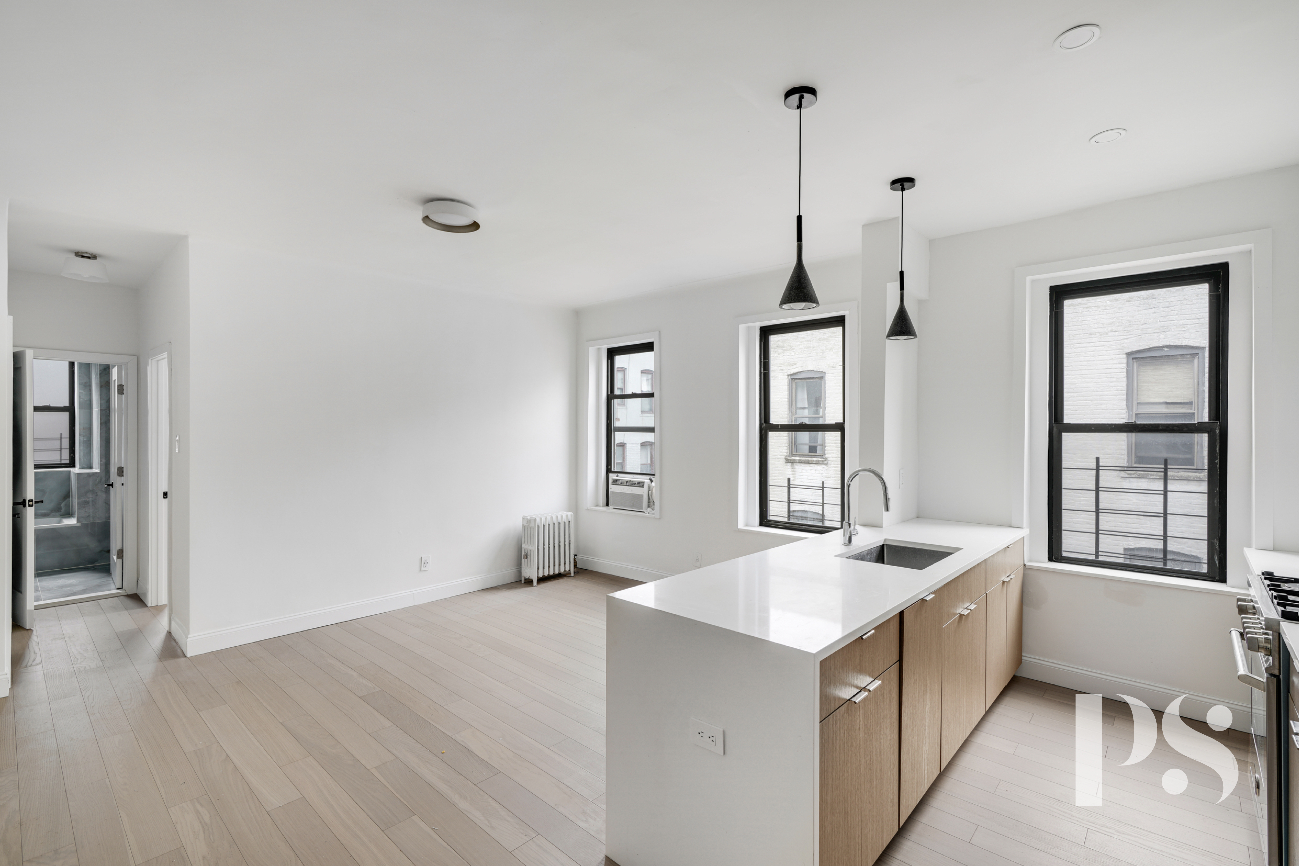 24-51 38th Street, Unit D1 Queens, NY 11103 - Photo 2 of 7 a kitchen that has a sink a stove and a wooden floor