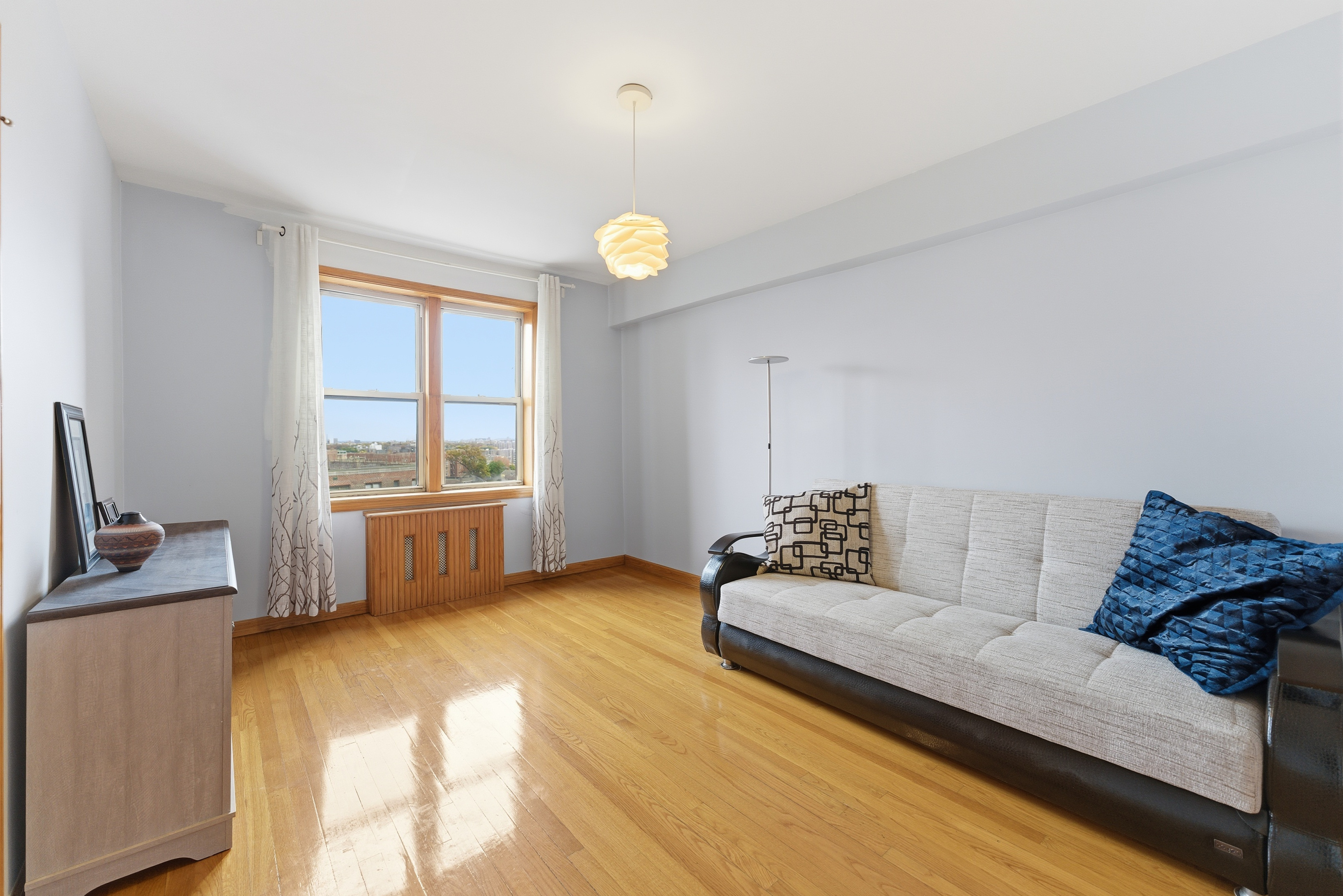 3616 Henry Hudson Parkway, Unit 7GN Bronx, NY 10463 - Photo 10 of 17 a living room with furniture and a window