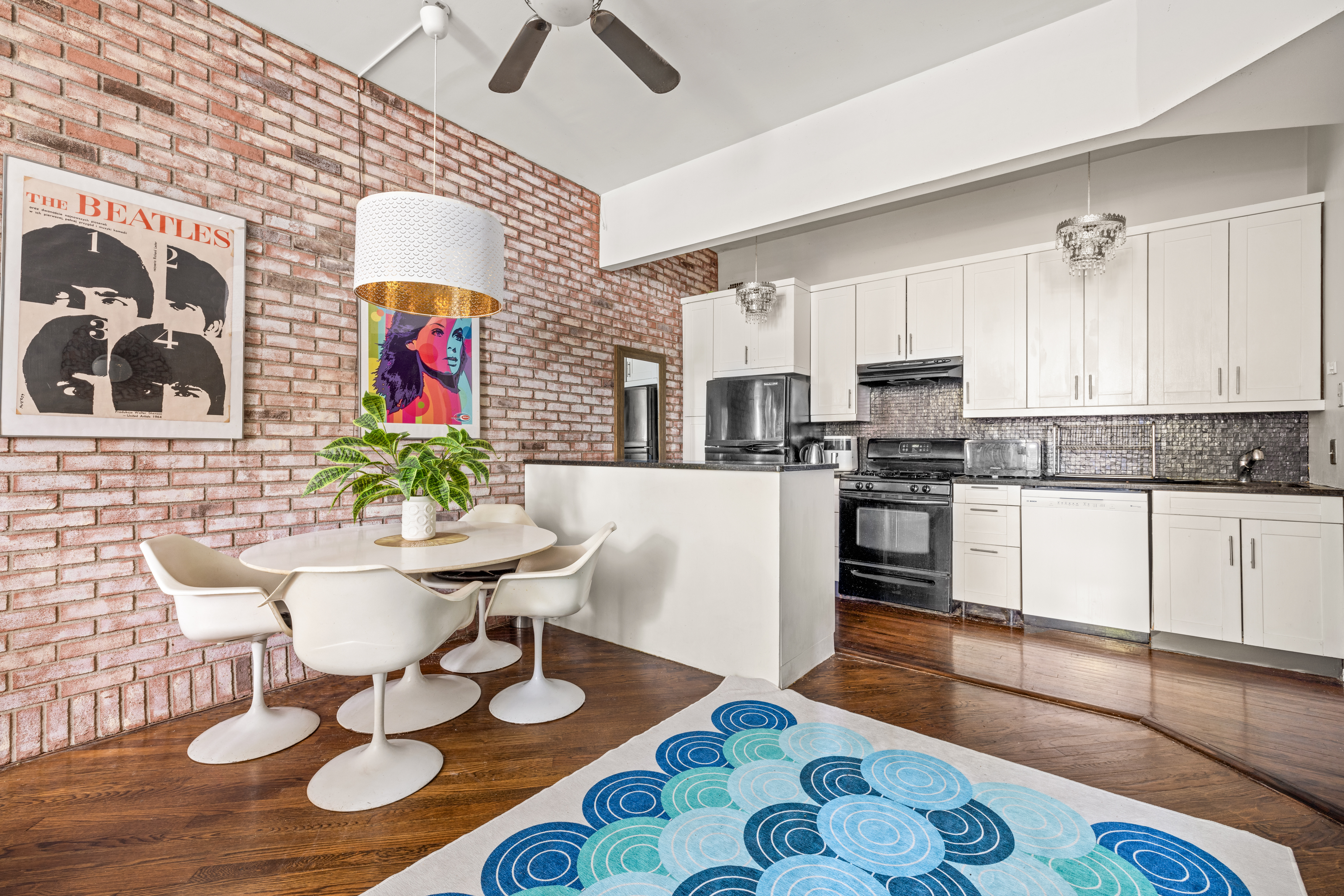 376 Bergen Street, Unit 1R Brooklyn, NY 11217 - Photo 6 of 10 a kitchen with stainless steel appliances kitchen island granite countertop a sink and a stove
