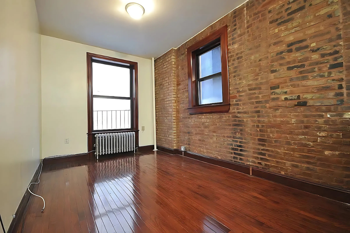 422 Amsterdam Avenue, Unit 3A Manhattan, NY 10024 - Photo 2 of 11 a view of an empty room with a window and wooden floor