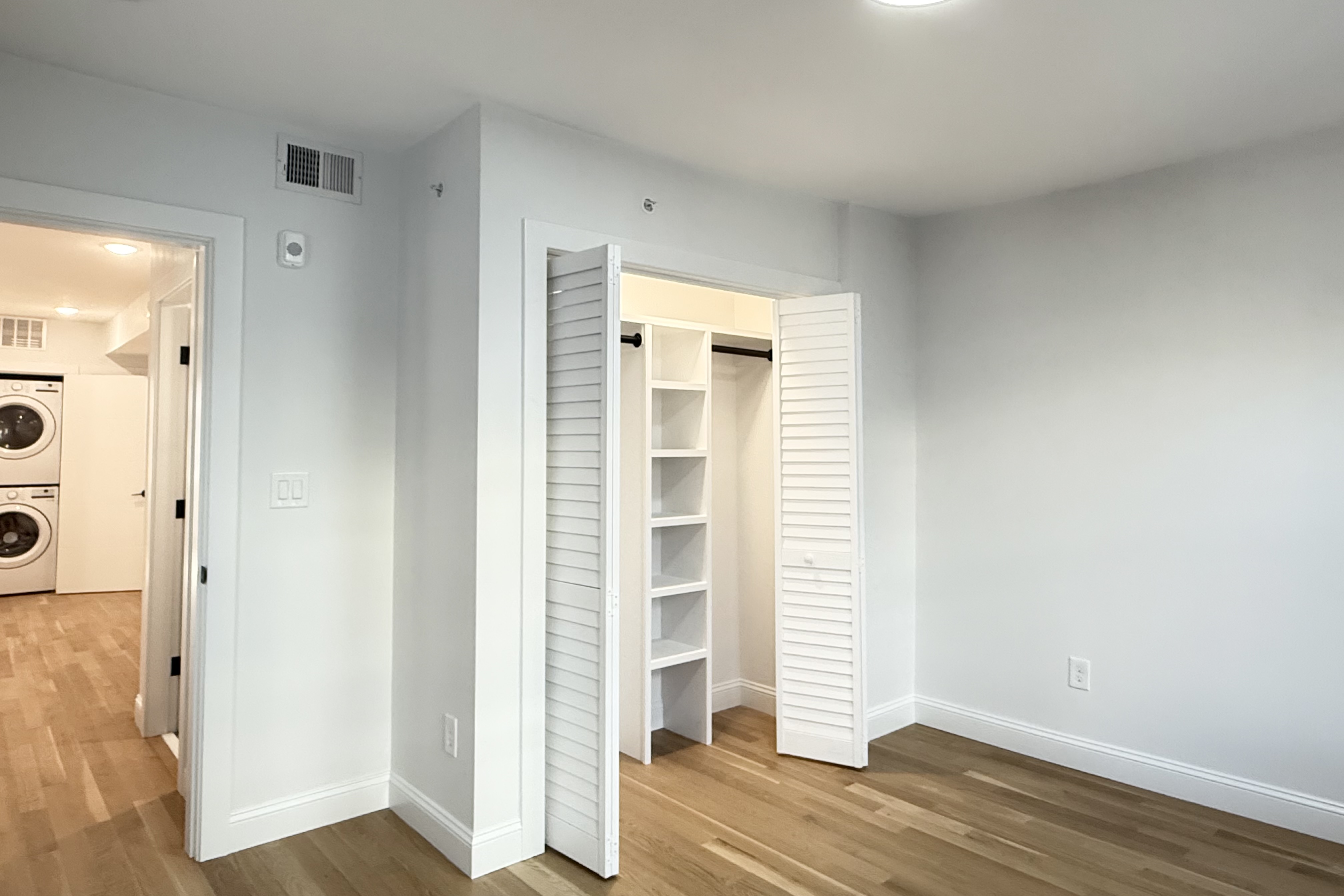 76 Webster Street East Boston, MA 02128 - Photo 6 of 8 a view of a bedroom with wooden floor and a window