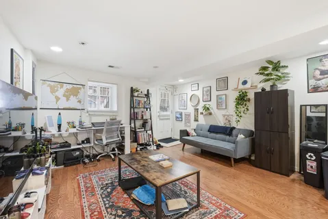 a living room with furniture a rug and a flat screen tv
