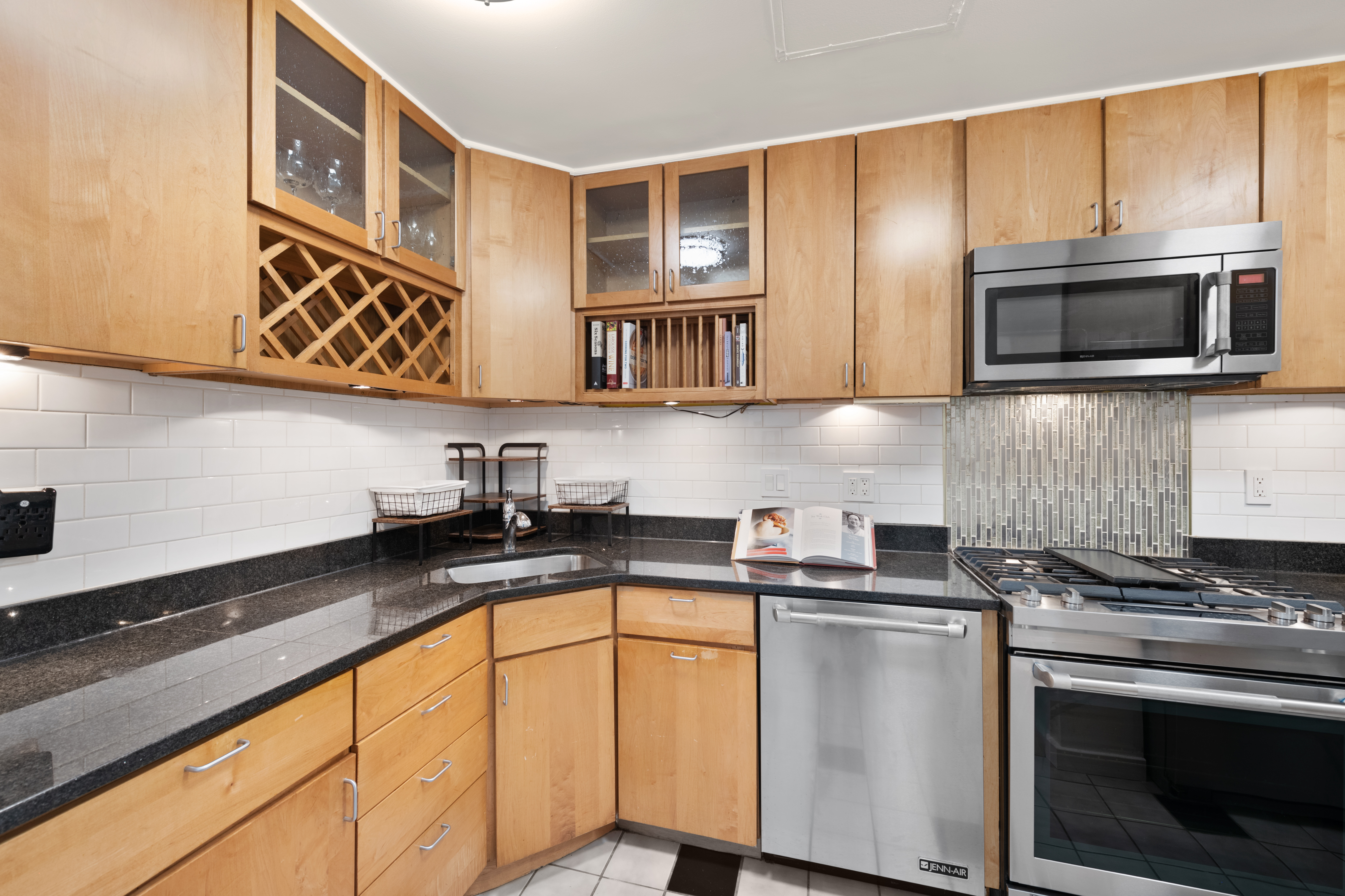490 M Street Southwest, Unit W802 Washington, DC 20024 - Photo 11 of 24 a kitchen with stainless steel appliances granite countertop a sink stove and microwave