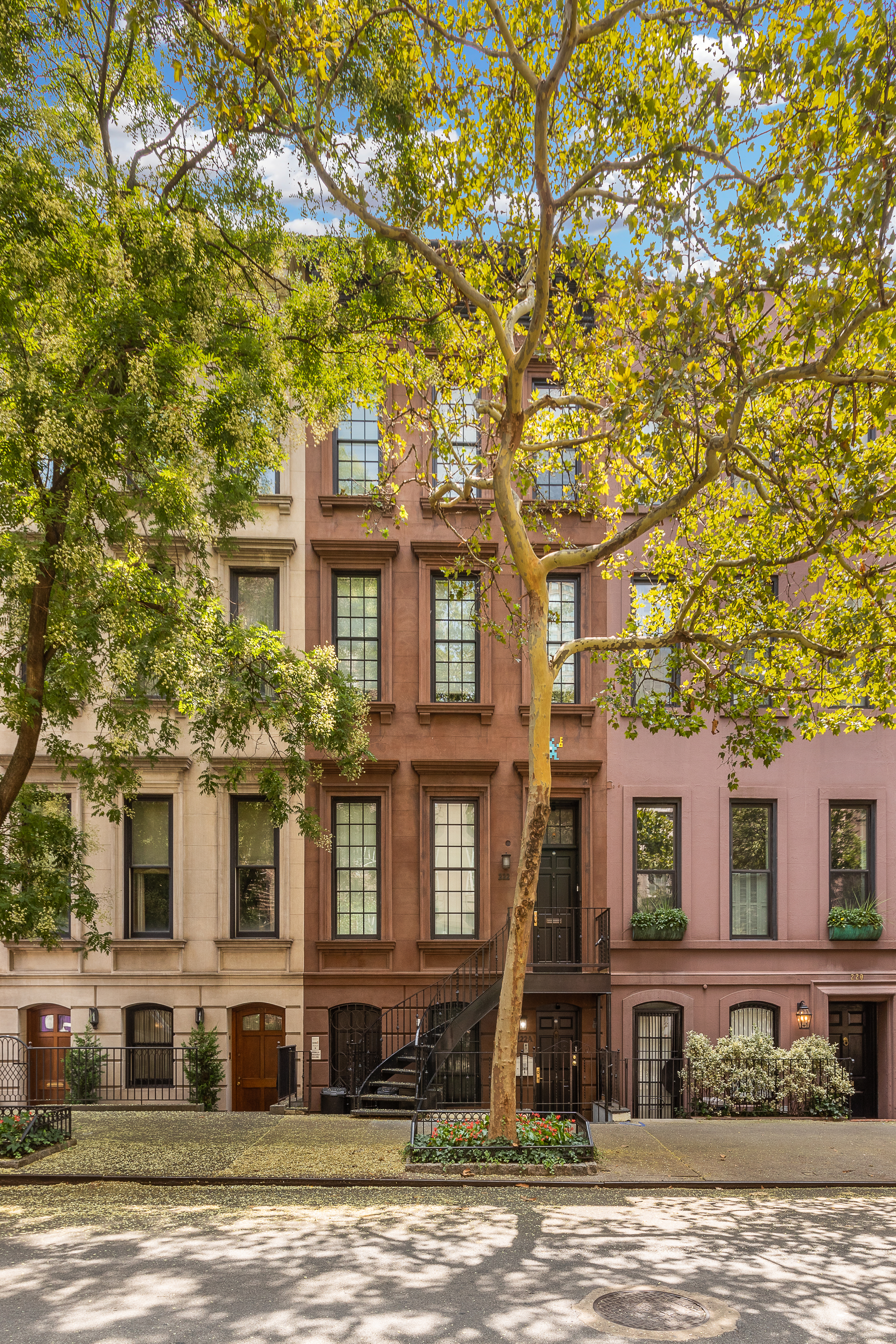 222 East 61st Street Manhattan, NY 10065 - Photo 26 of 30 a front view of a house with a yard