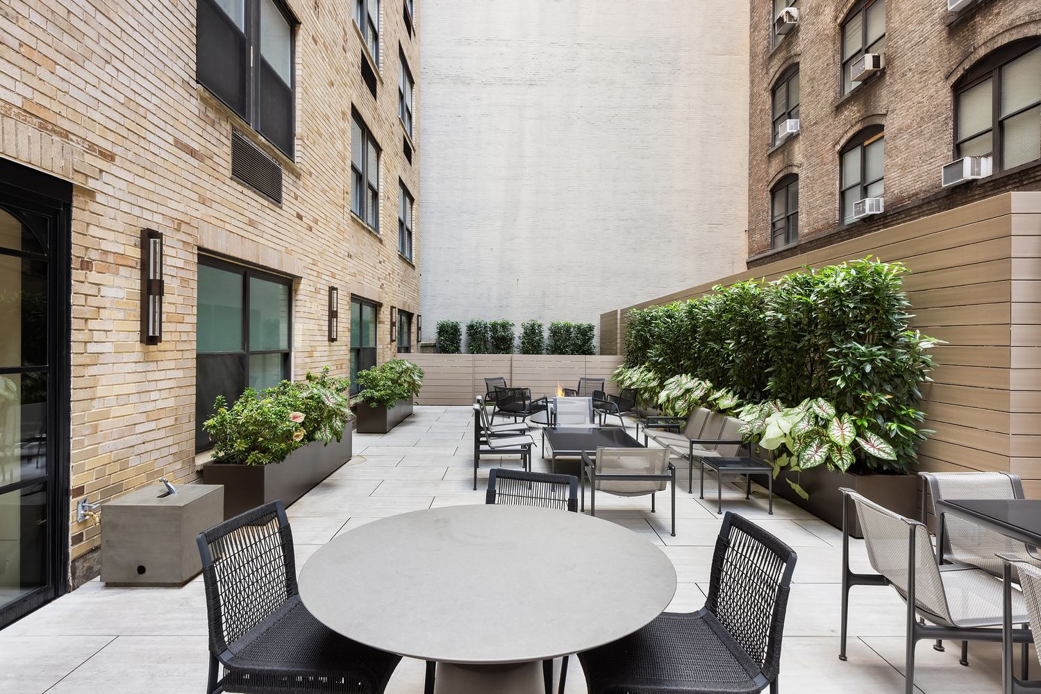 a view of a patio with couches table and chairs and potted plants
