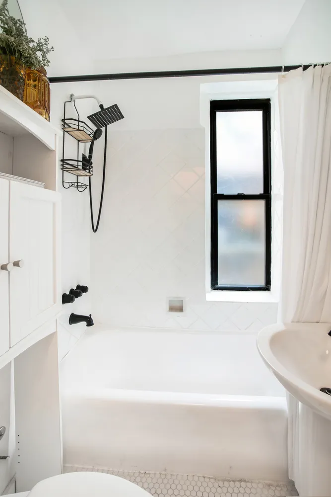 a bathroom with a bathtub and a shower