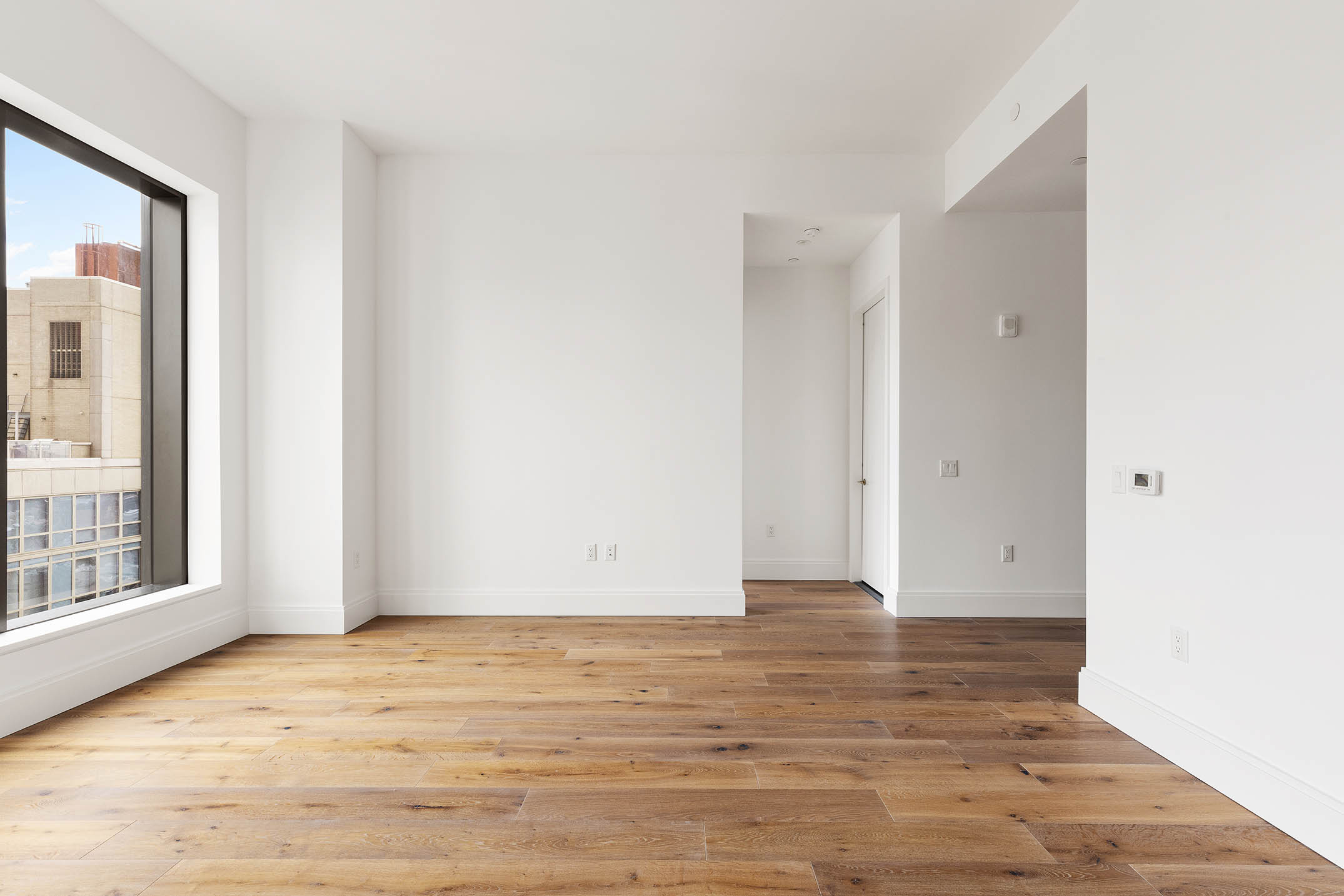 30 East 29th Street, Unit 31B Manhattan, NY 10016 - Photo 5 of 9 a view of an empty room with wooden floor and a window