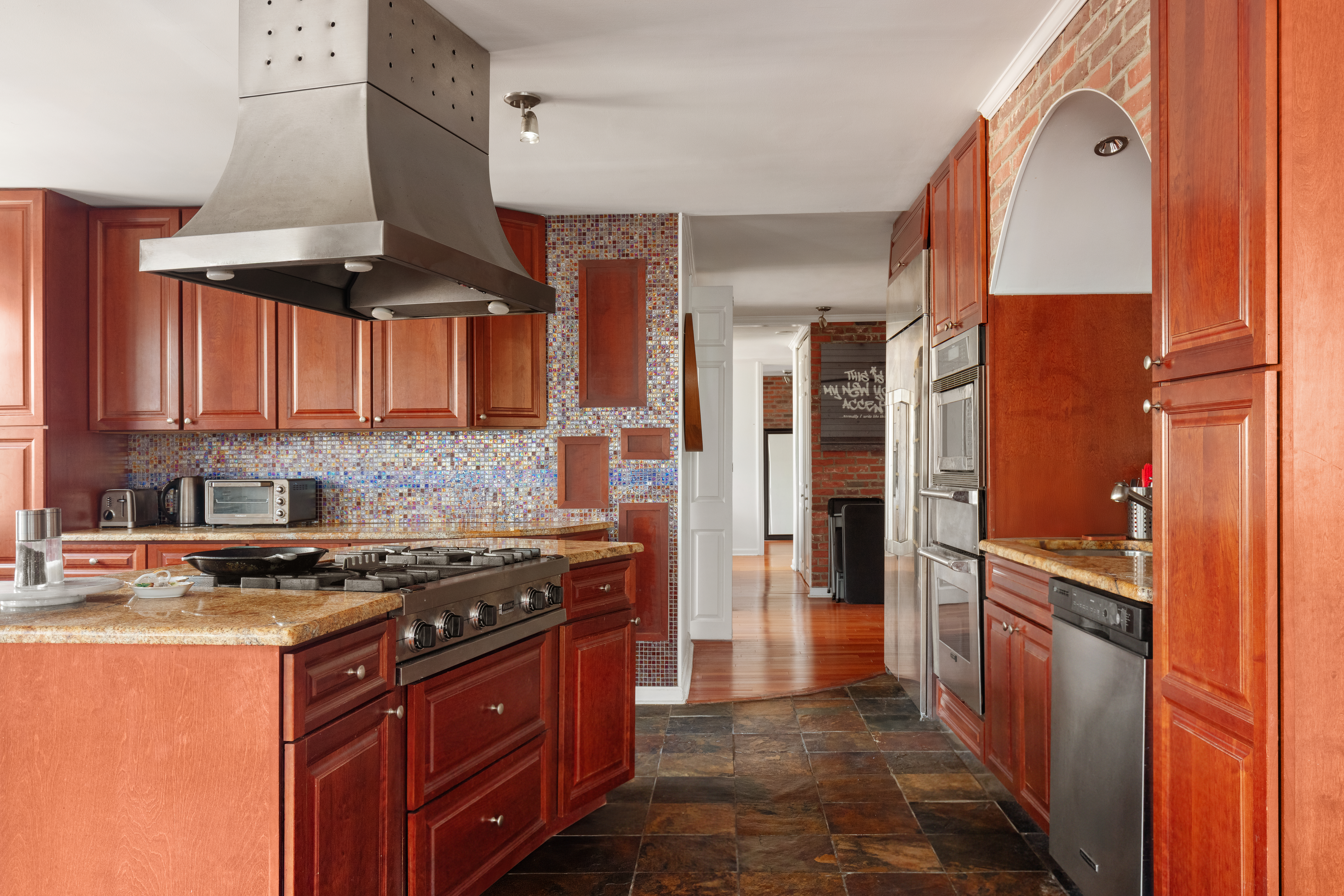 400 East 54th Street, Unit 21CDE Manhattan, NY 10022 - Photo 5 of 10 a kitchen with stainless steel appliances granite countertop a stove and a refrigerator