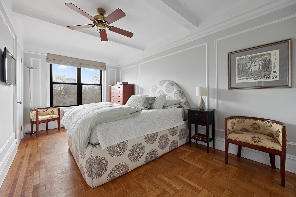 415 Central Park West, Unit 6A Manhattan, NY 10025 - Photo 16 of 25 a bedroom with a bed a couch and a chandelier