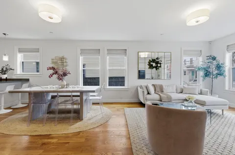 a living room with fireplace furniture and a table