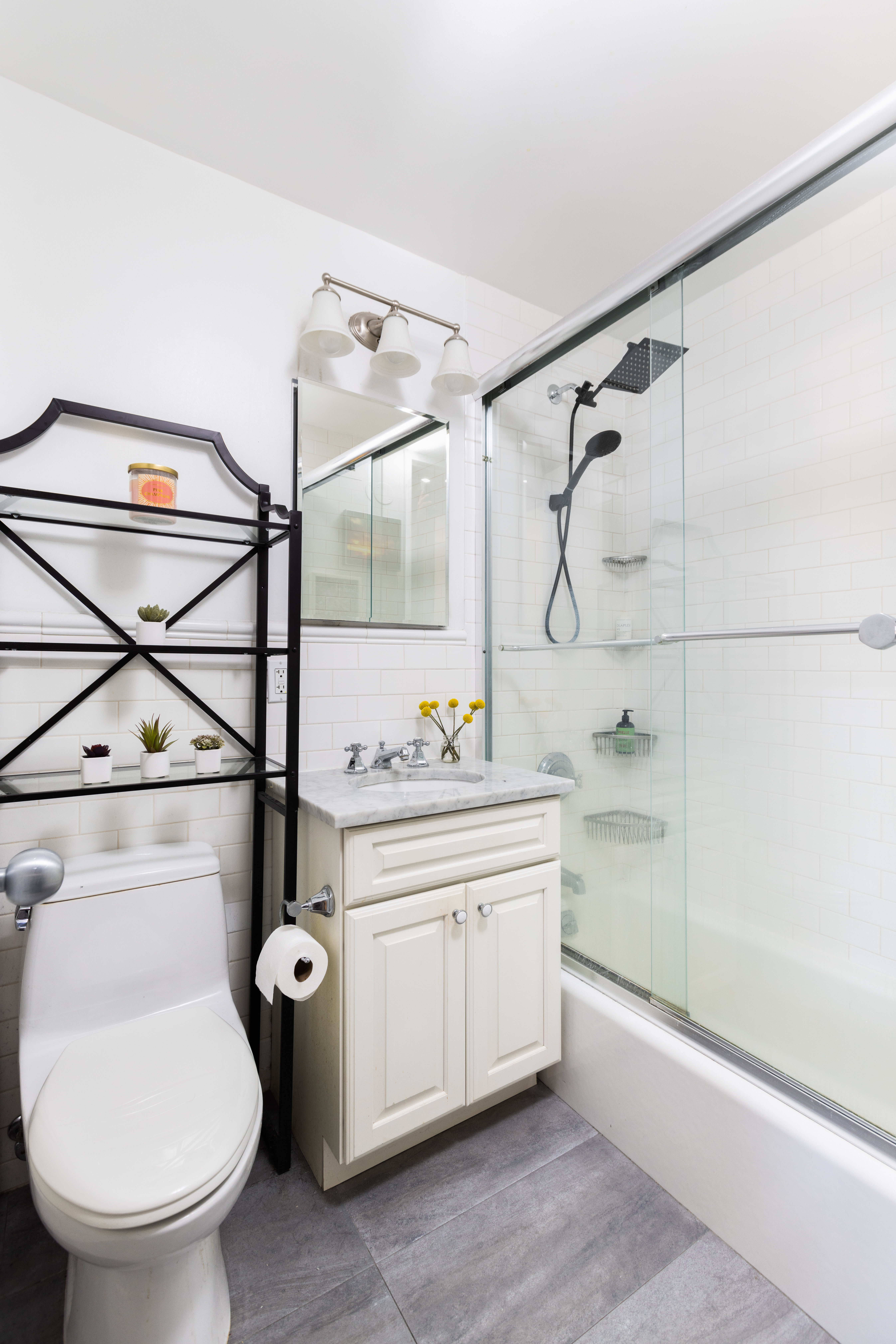 245 East 25th Street, Unit 19L Manhattan, NY 10010 - Photo 8 of 13 a bathroom with a sink a toilet and a shower