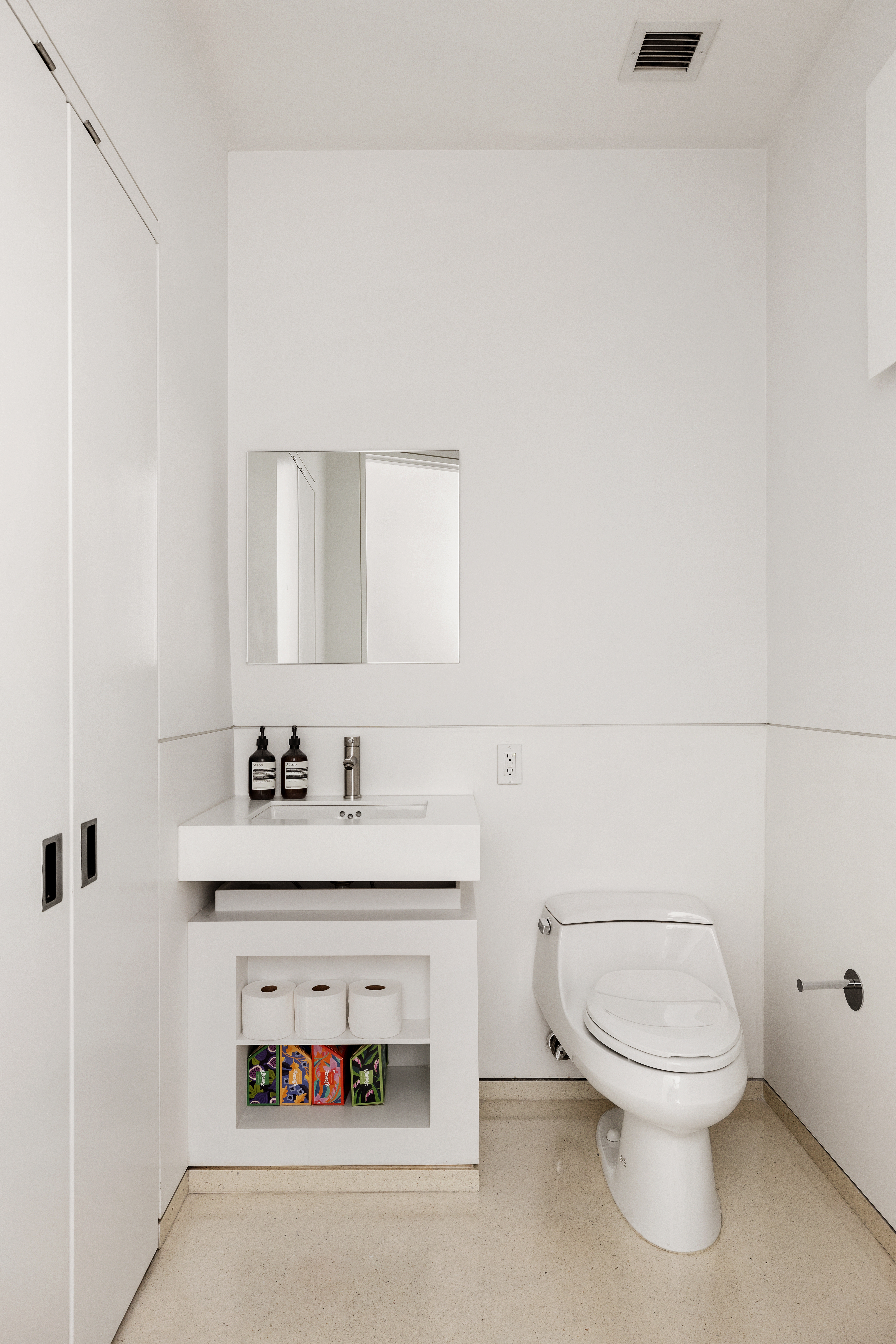 100 11th Avenue, Unit 7D Manhattan, NY 10011 - Photo 9 of 15 a bathroom with a toilet a sink and mirror