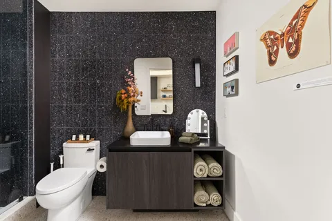 a bathroom with a toilet a sink and a mirror