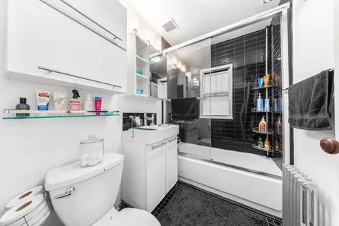 a bathroom with a sink a toilet and a shower